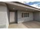 Inviting entrance with covered porch featuring neutral stucco and a window bringing in light at 1330 W Gee St, Pahrump, NV 89060