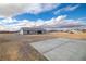 Rear exterior view of single-story home and parking pad at 1330 W Gee St, Pahrump, NV 89060