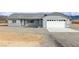 Well-maintained home featuring a large garage and desert landscaping at 1330 W Gee St, Pahrump, NV 89060