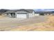Single-story home featuring multiple garages and easy care landscaping at 1330 W Gee St, Pahrump, NV 89060