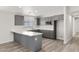 Modern kitchen boasts gray cabinets, stainless steel appliances, and attractive countertops at 1330 W Gee St, Pahrump, NV 89060