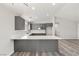 Bright kitchen offers an island with quartz countertops and stainless steel appliances at 1330 W Gee St, Pahrump, NV 89060