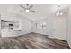An open living room featuring new flooring, a ceiling fan and bright natural light throughout at 1330 W Gee St, Pahrump, NV 89060