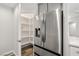 Stainless steel refrigerator next to large, organized pantry with shelving at 1330 W Gee St, Pahrump, NV 89060