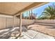 Covered back patio with decorative concrete and white fencing, ideal for outdoor living at 1665 Rowan Tree Dr, Las Vegas, NV 89123