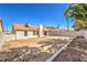 Backyard view features private lot with block wall, desert landscaping and shade from mature trees at 1665 Rowan Tree Dr, Las Vegas, NV 89123