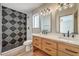 Stylish bathroom featuring a double vanity, modern lighting, and a beautifully tiled shower at 1665 Rowan Tree Dr, Las Vegas, NV 89123