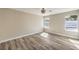 Well-lit bedroom with wood-look tile floors and large windows at 1665 Rowan Tree Dr, Las Vegas, NV 89123