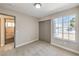 Comfortable bedroom with carpet, a large window and an en-suite bathroom at 1665 Rowan Tree Dr, Las Vegas, NV 89123