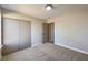 Bedroom with plush carpeting, a large window and a closet with sliding doors at 1665 Rowan Tree Dr, Las Vegas, NV 89123