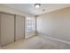 Cozy bedroom with plush carpeting, a large window, and a closet with sliding doors at 1665 Rowan Tree Dr, Las Vegas, NV 89123