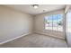 Inviting bedroom with carpet, a large window with natural light at 1665 Rowan Tree Dr, Las Vegas, NV 89123