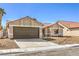 Charming single-story home featuring a well-manicured front yard and a two-car garage at 1665 Rowan Tree Dr, Las Vegas, NV 89123