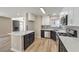 Updated kitchen with stainless steel appliances, quartz countertops, and modern cabinetry at 1665 Rowan Tree Dr, Las Vegas, NV 89123