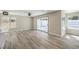 Bright living room with wood-look tile floors and sliding door access to the outdoor patio at 1665 Rowan Tree Dr, Las Vegas, NV 89123