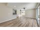 Open living area with wood-look tile floors, view to the kitchen and access to the backyard at 1665 Rowan Tree Dr, Las Vegas, NV 89123