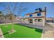 Expansive backyard with lush artificial turf and a covered patio, perfect for entertaining guests outdoors at 1904 Roxbury Ln, Las Vegas, NV 89119