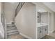 Stylish bar area featuring designer backsplash, sink, and staircase access at 1904 Roxbury Ln, Las Vegas, NV 89119