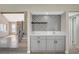 Entertain with ease in this stylish bar area featuring a tile backsplash and quartz countertop at 1904 Roxbury Ln, Las Vegas, NV 89119