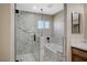 Bathroom featuring a tub and frameless glass-enclosed shower with elegant marble-look tile at 1904 Roxbury Ln, Las Vegas, NV 89119
