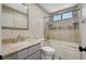 Bathroom featuring a vanity with granite countertop and a shower over tub with glass door at 1904 Roxbury Ln, Las Vegas, NV 89119