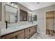 Bathroom with a double vanity featuring modern vessel sinks and wood-look cabinetry at 1904 Roxbury Ln, Las Vegas, NV 89119