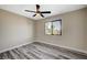 Bedroom featuring wood-look floors and a window letting in natural light at 1904 Roxbury Ln, Las Vegas, NV 89119