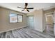 Bedroom featuring wood-look floors, closet, window, and a ceiling fan at 1904 Roxbury Ln, Las Vegas, NV 89119