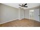 Bright bedroom featuring a ceiling fan, wood flooring, and ensuite bathroom access at 1904 Roxbury Ln, Las Vegas, NV 89119