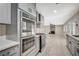 Stainless steel appliances and gray cabinets highlight this kitchen's modern design and ample open floorplan at 1904 Roxbury Ln, Las Vegas, NV 89119