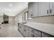 Bright kitchen boasts modern gray cabinets, stainless steel appliances, and quartz countertops at 1904 Roxbury Ln, Las Vegas, NV 89119