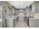 Well-equipped kitchen featuring gray cabinetry, stainless steel appliances, and bright countertops at 1904 Roxbury Ln, Las Vegas, NV 89119