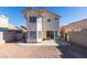 A fully fenced private backyard featuring gravel, a small concrete patio, and desert landscaping at 1989 Bookbinder Dr, Las Vegas, NV 89108