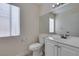 Bright bathroom featuring white vanity, toilet and mirror plus natural light from window at 1989 Bookbinder Dr, Las Vegas, NV 89108