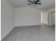 This bright room has fresh paint, a ceiling fan, gray flooring and a door to the bathroom at 1989 Bookbinder Dr, Las Vegas, NV 89108