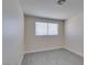 This bedroom features fresh paint, gray flooring, and a window that provides plenty of natural light at 1989 Bookbinder Dr, Las Vegas, NV 89108