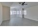 This spacious bedroom has lots of natural light, gray floors, and ceiling fan at 1989 Bookbinder Dr, Las Vegas, NV 89108