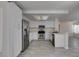 Open kitchen with stainless steel appliances, white cabinets and breakfast bar area at 1989 Bookbinder Dr, Las Vegas, NV 89108
