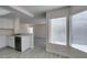 Corner of kitchen featuring stainless steel appliances, a sink, white cabinets, and gray wood-look flooring at 1989 Bookbinder Dr, Las Vegas, NV 89108