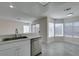 Kitchen with stainless steel appliances, a sink, stone countertops, and gray wood-look flooring at 1989 Bookbinder Dr, Las Vegas, NV 89108