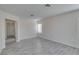 Bright room with grey floors, neutral walls and entryway to another room at 1989 Bookbinder Dr, Las Vegas, NV 89108
