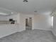 Open-concept floorplan with eat-in kitchen, grey floors, and access to other rooms at 1989 Bookbinder Dr, Las Vegas, NV 89108