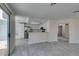 Open concept living area with eat-in kitchen, light walls, grey floors, and access to outdoor area at 1989 Bookbinder Dr, Las Vegas, NV 89108
