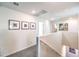 Upstairs hallway with neutral walls, gray carpeting and artwork hung on the wall at 200 Biscotti Ave # Lot 122, North Las Vegas, NV 89084