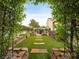 A well-manicured backyard with artificial turf, paver stepping stones and charming greenery at 2008 Hobbyhorse Ave, Henderson, NV 89012