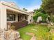 A backyard with covered patio, outdoor kitchen, manicured green archway, patio, and lush landscaping at 2008 Hobbyhorse Ave, Henderson, NV 89012