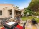 A spacious backyard featuring an outdoor kitchen, green archway, patio, and well-maintained landscaping at 2008 Hobbyhorse Ave, Henderson, NV 89012