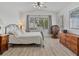 Light and bright bedroom has hardwood floors, a ceiling fan, and large dresser at 2008 Hobbyhorse Ave, Henderson, NV 89012