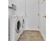 Laundry room features tile flooring and front loading washer and dryer at 2008 Hobbyhorse Ave, Henderson, NV 89012