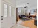 Inviting living room showcasing a window wall, hardwood floors, contemporary decor, and a stylish ceiling fan at 2008 Hobbyhorse Ave, Henderson, NV 89012